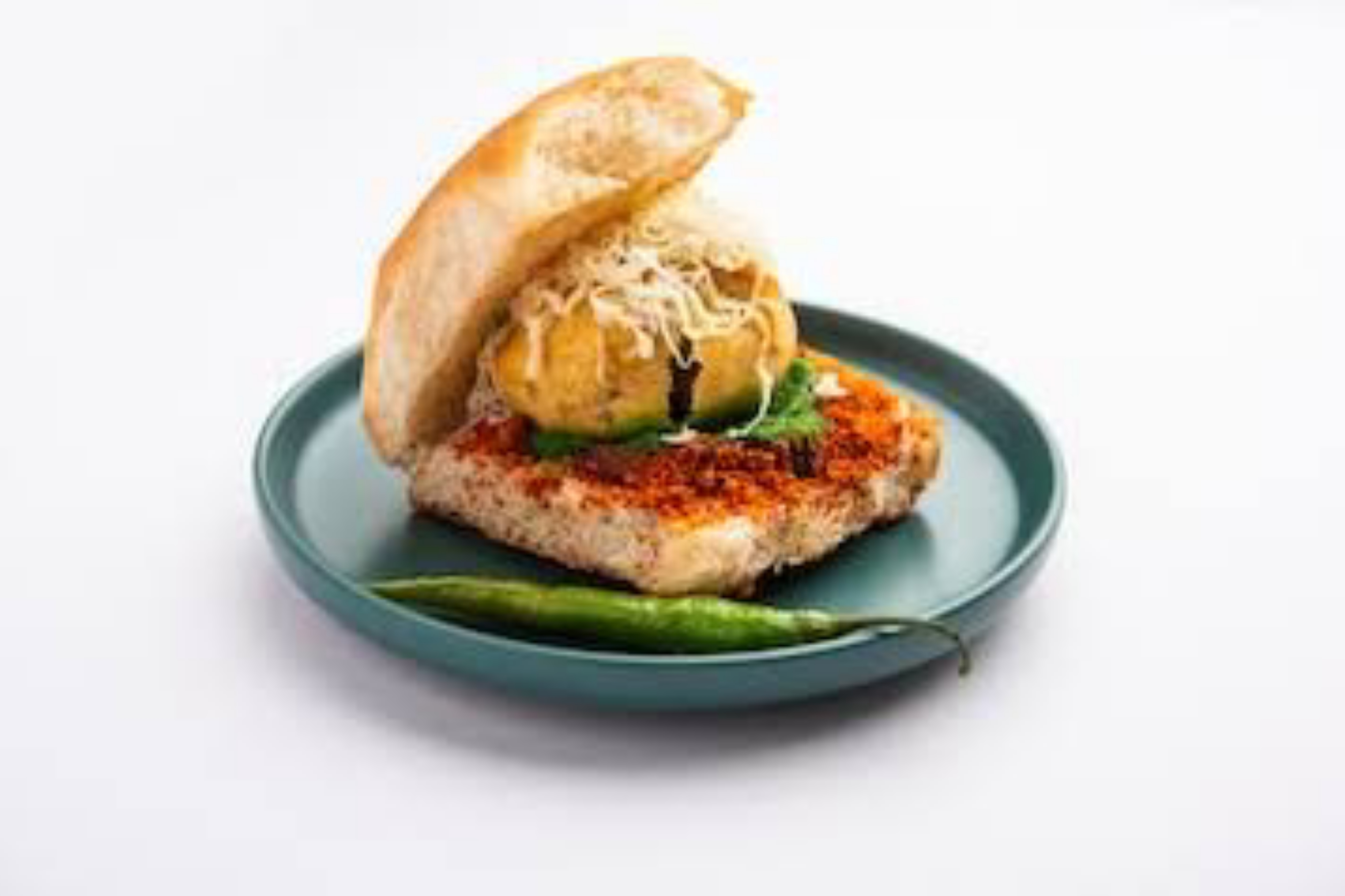 Cheese vada pav with melted cheese and green chutney